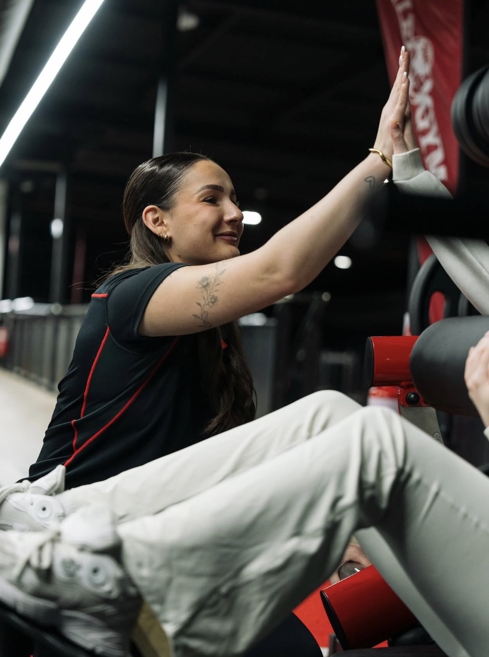 Dana high-fiving a client during a training session